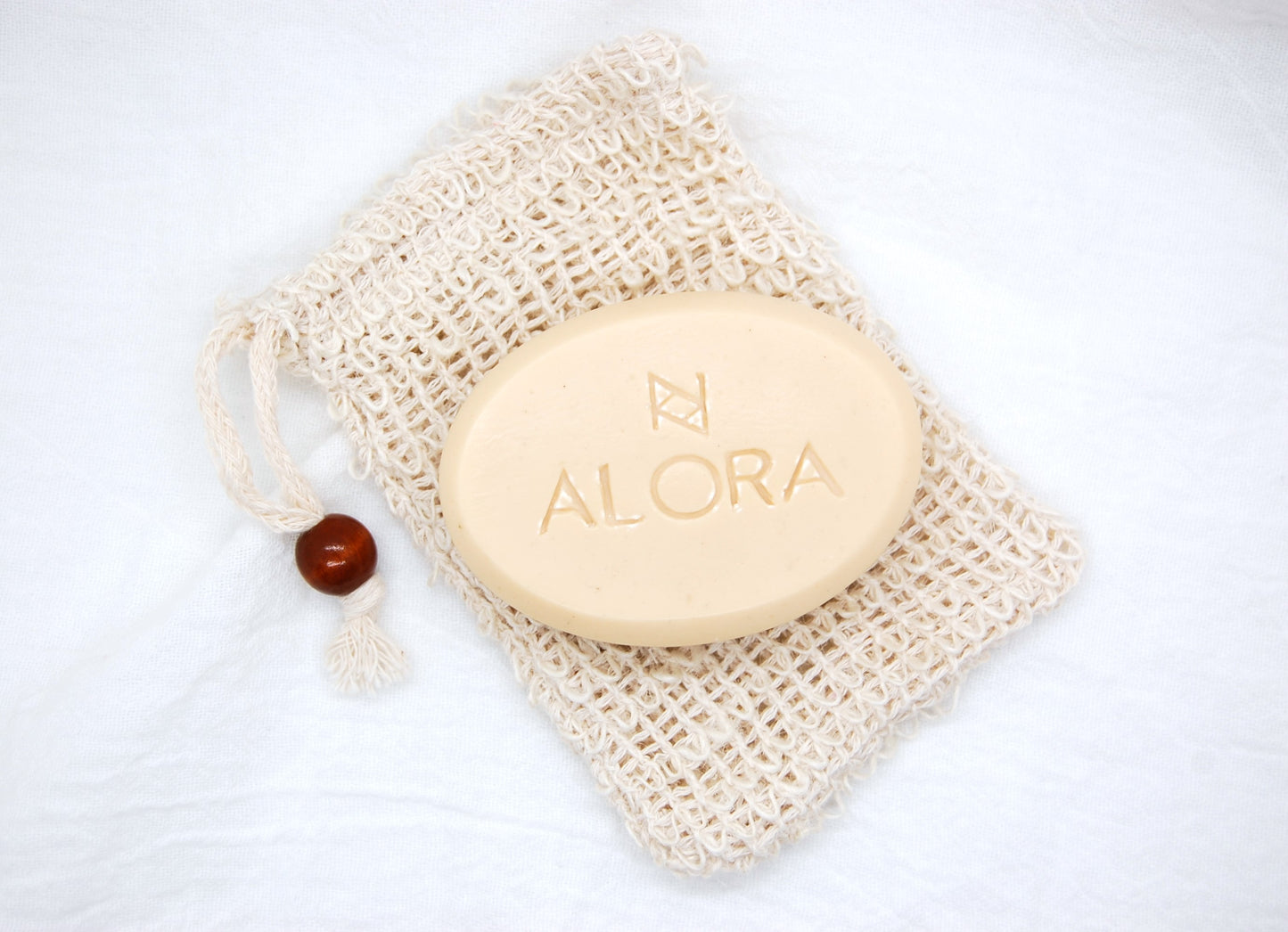 Unscented all-natural goat milk bar soap by AloraCo with soap saver bag 